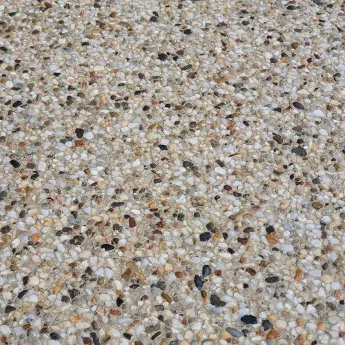 Exposed aggregate driveway featuring a blend of granite and river pebbles, exemplifying durability and curb appeal